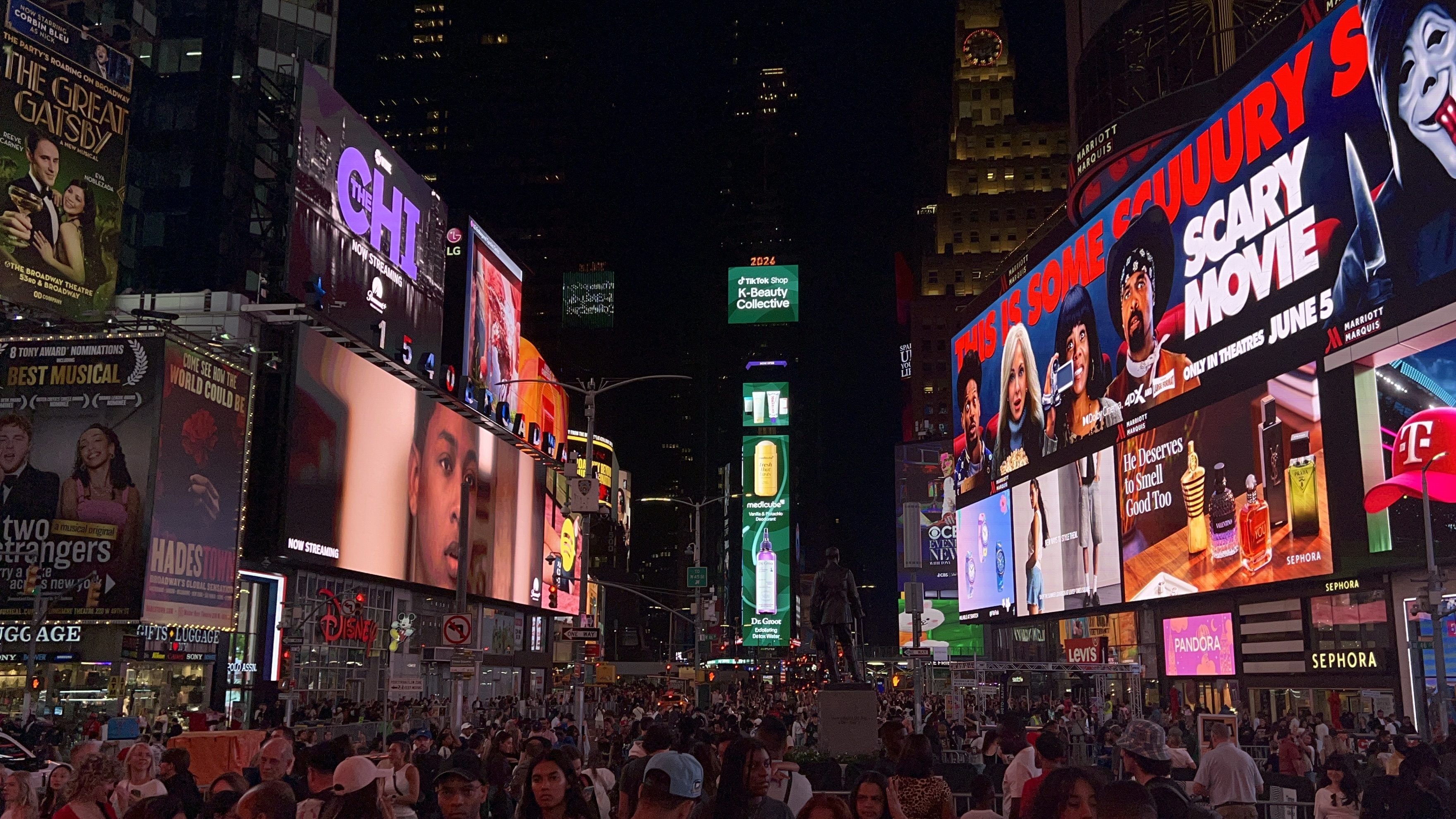 Times Square at night — illuminated LED billboards and crowds